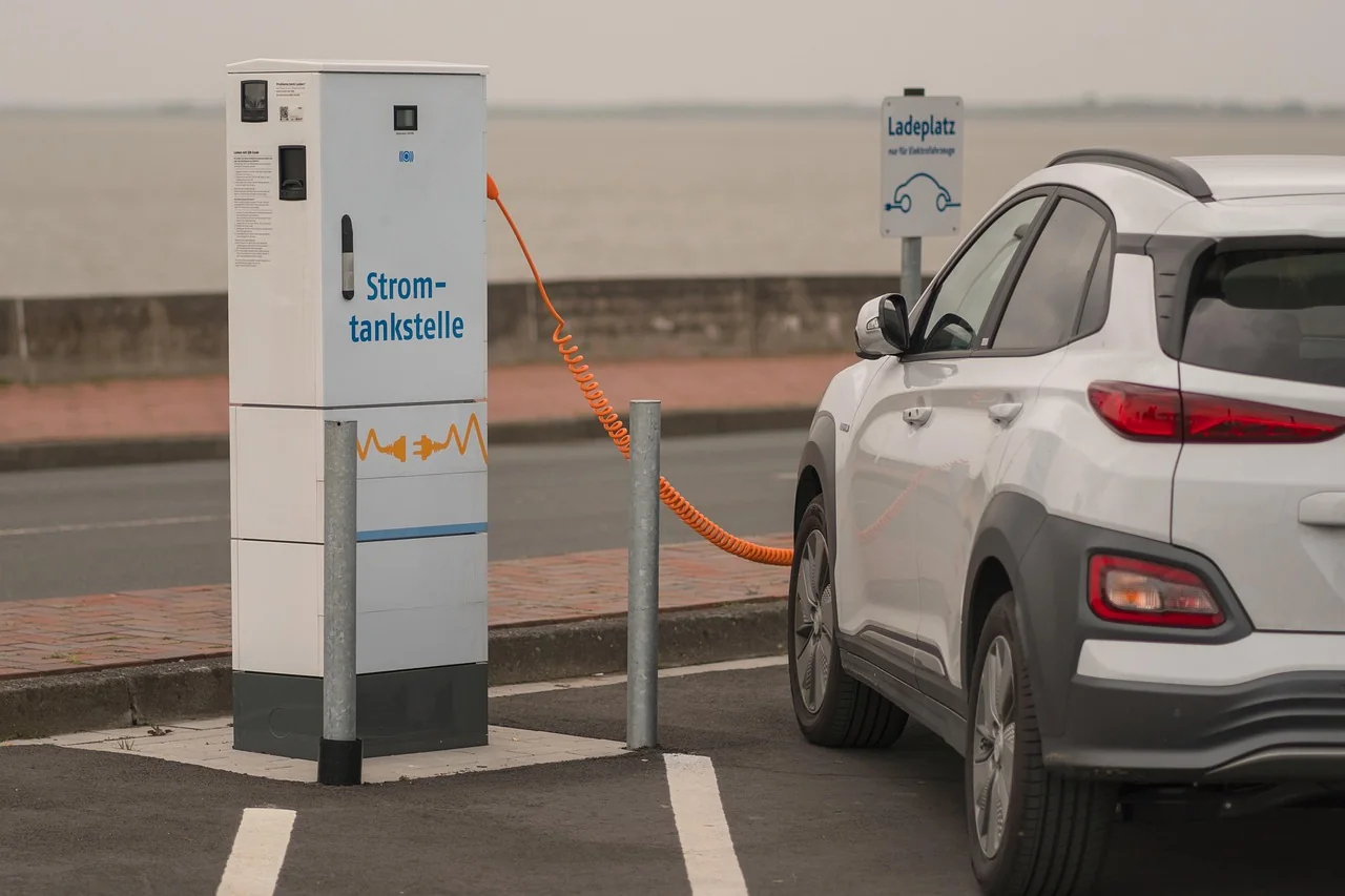 Electric car plugged into a public charging station in a car park