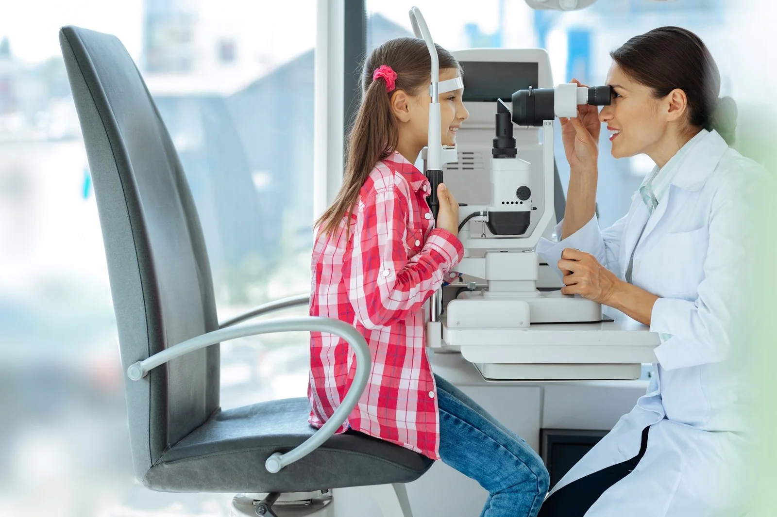 Doctor checking a girl's eyesight