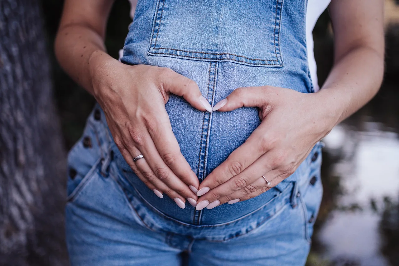 Pregnant woman holding her belly, preparing to give birth in Cyprus