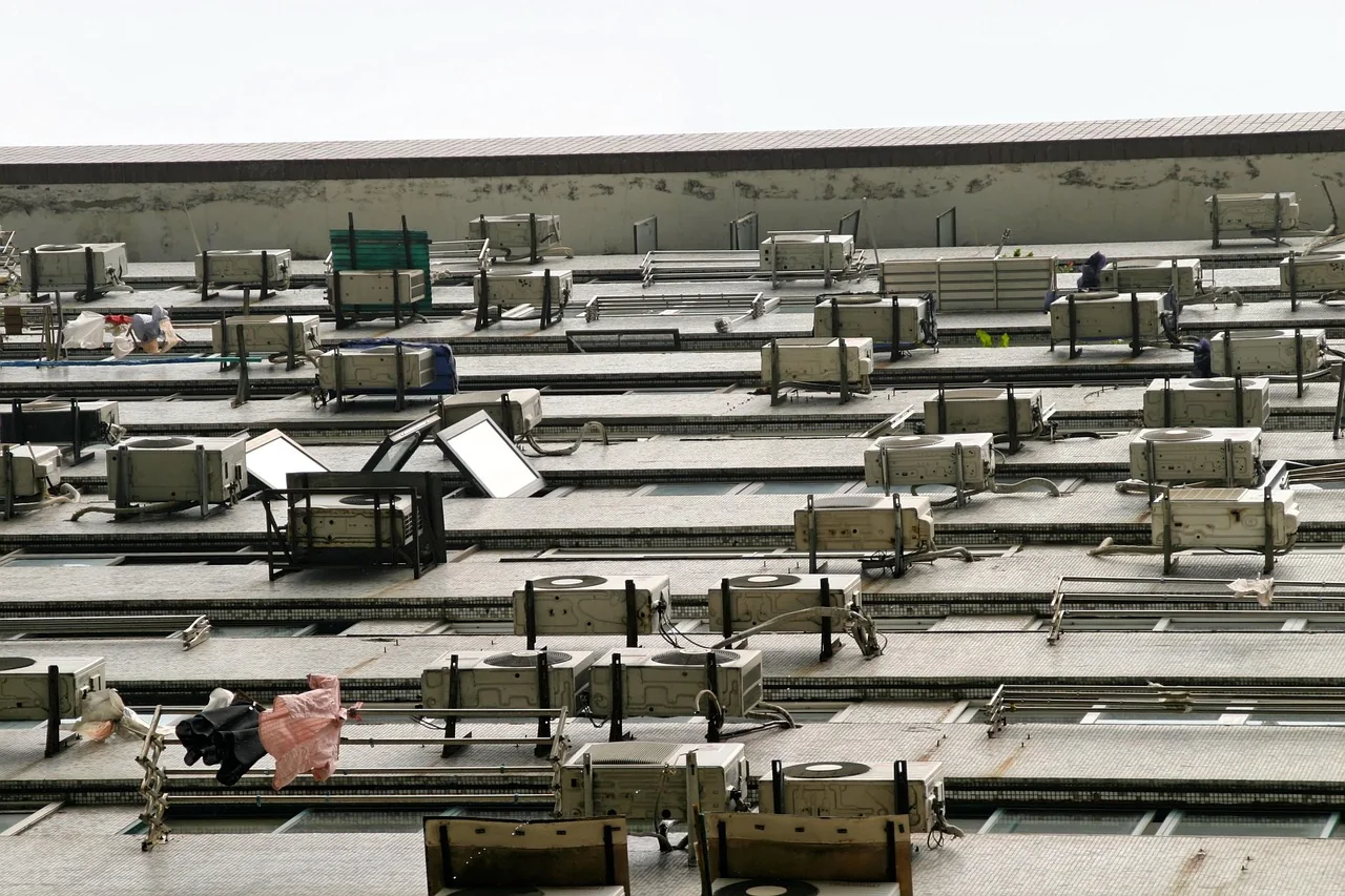 Outdoor units of air-conditioning heat pumps mounted on the wall of an apartment building