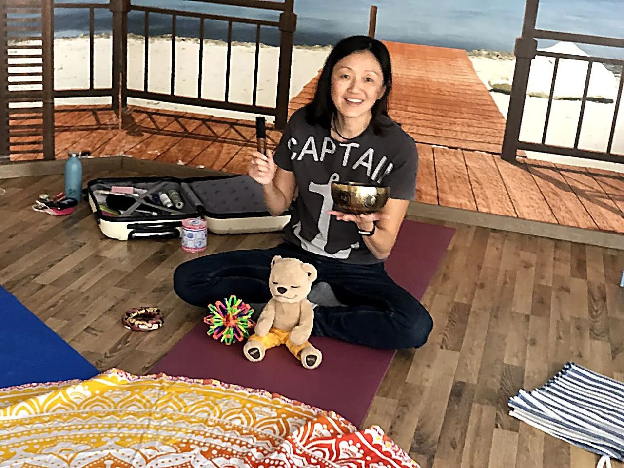 Judy, mindfulness and meditation teacher for children, with a singing bowl before a kids' meditation class