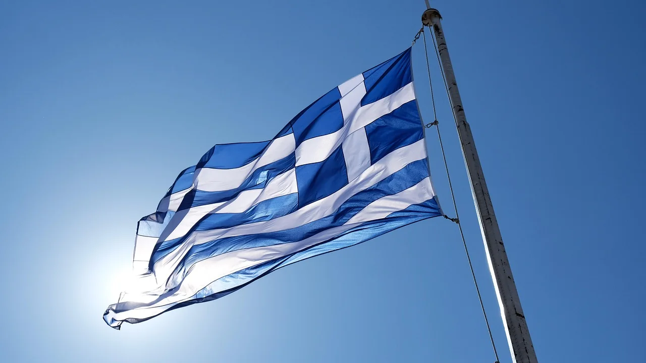Greek flag flying against a blue sky, as on Ohi Day (28 October) in Cyprus
