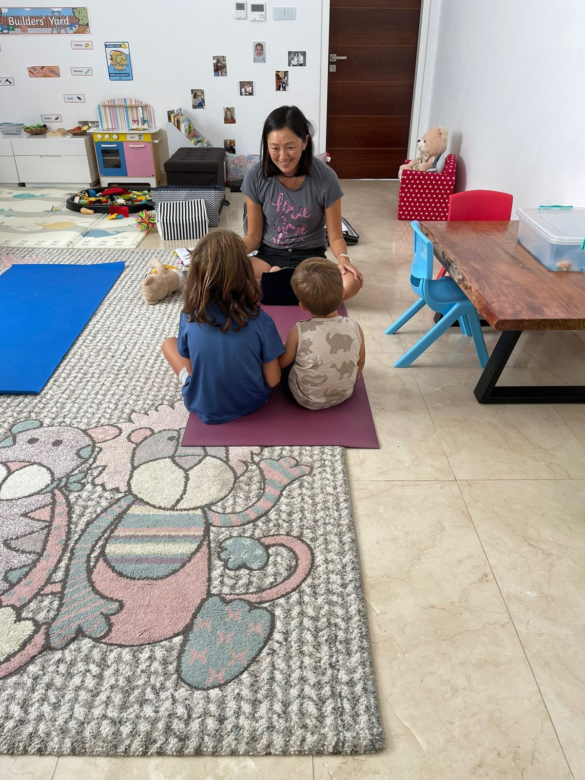 Judy Lam leading a mindfulness session for children on yoga mats