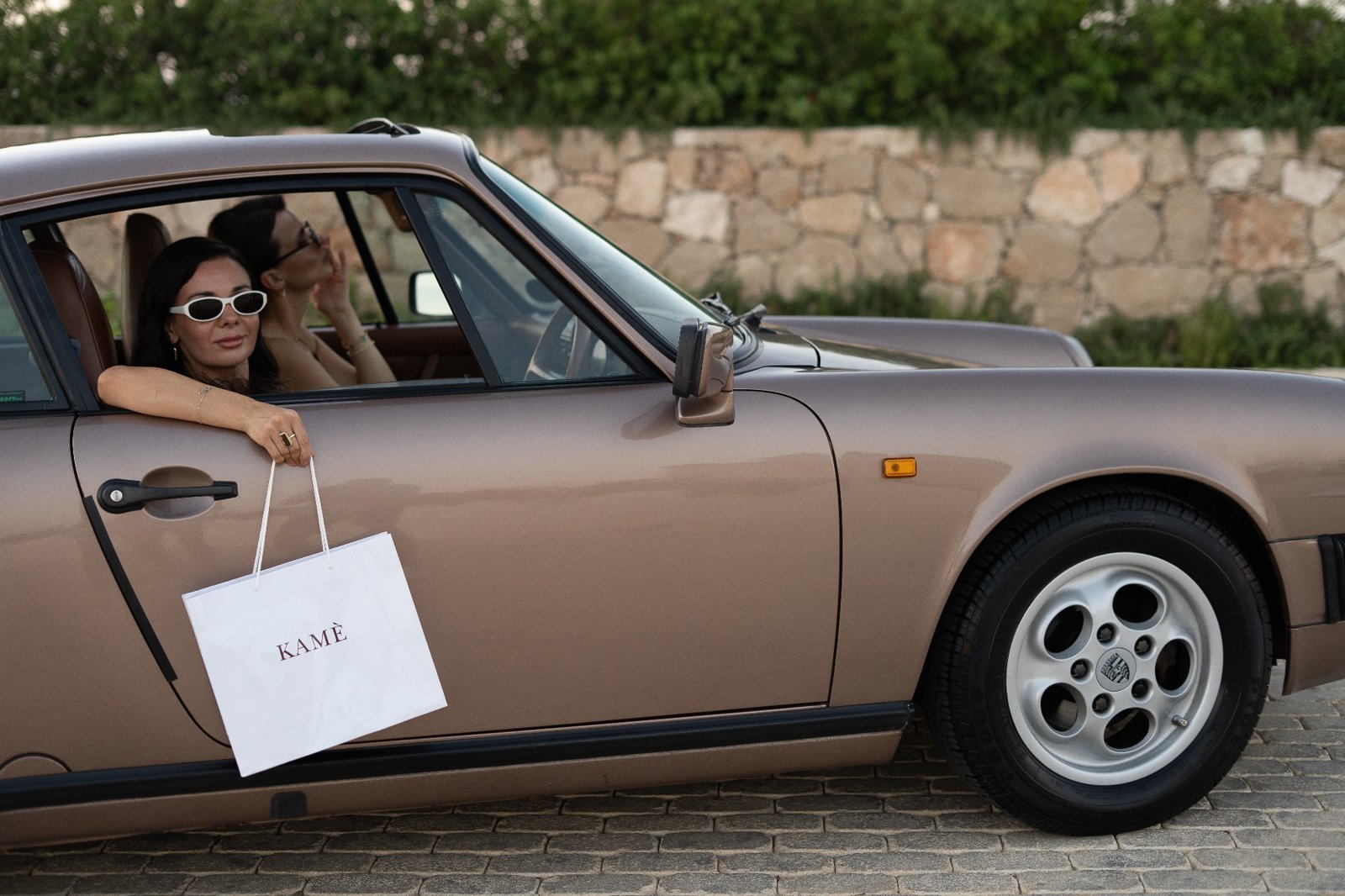 Simona in a vintage car with a KAMÈ shopping bag in Paphos