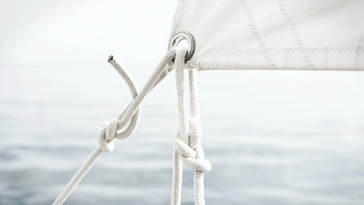 Sailing boat under full sail on a calm blue Mediterranean sea