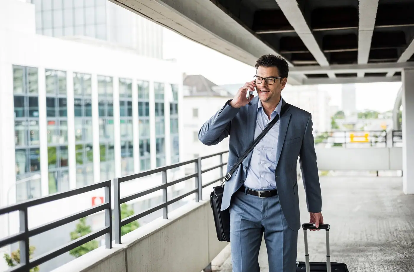 Businessman on a business trip talking on a smartphone