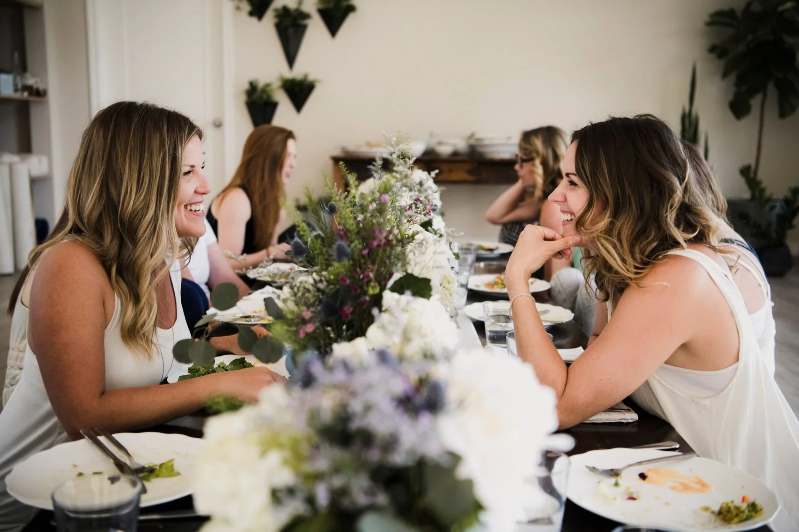 Women enjoying friendship and a meal at a yoga retreat