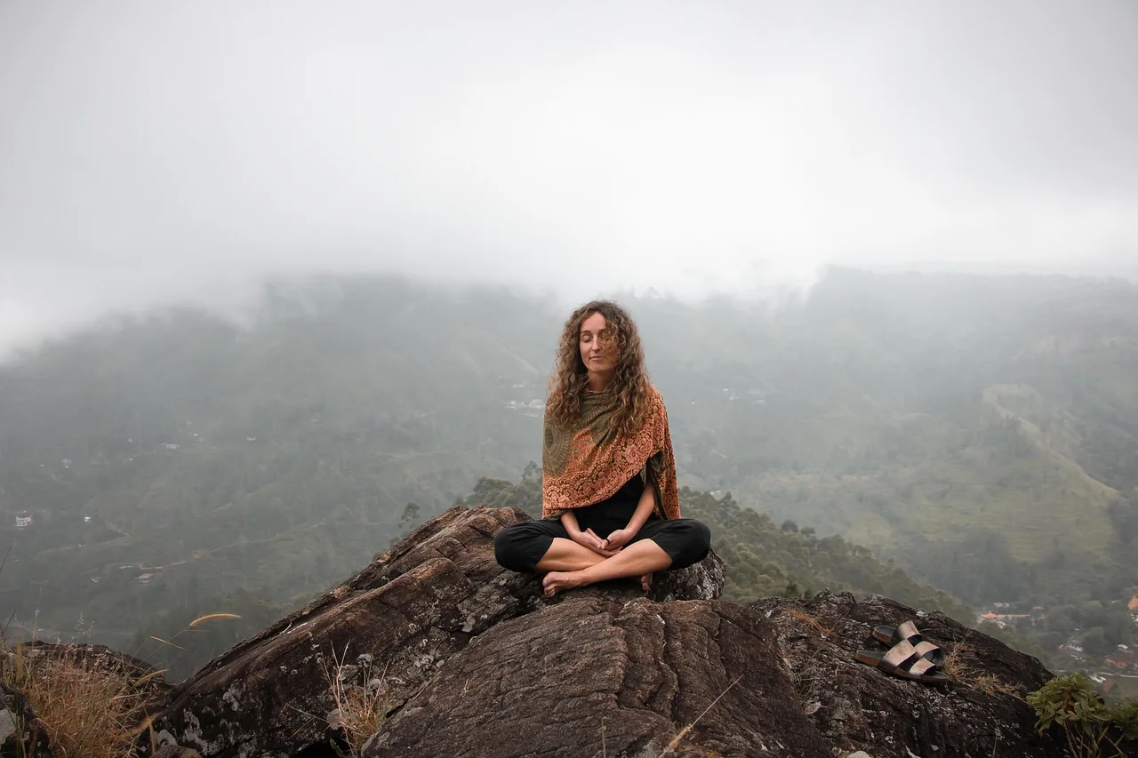 Woman practising yoga outdoors at a wellness retreat in the Mediterranean countryside