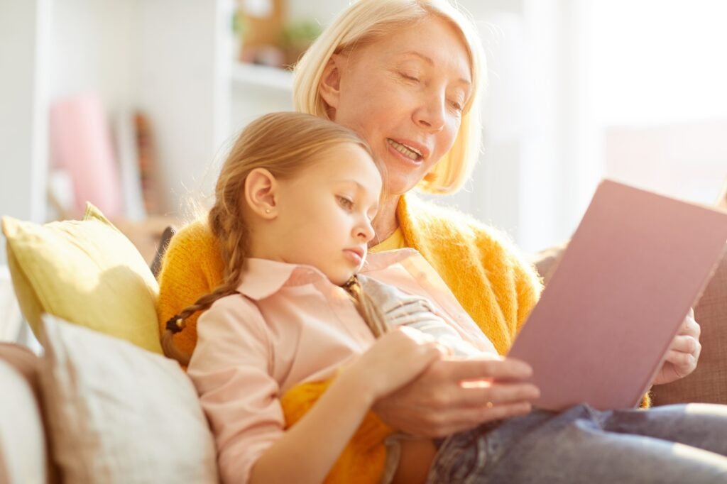 Mother reading stories to her child in sunlight
